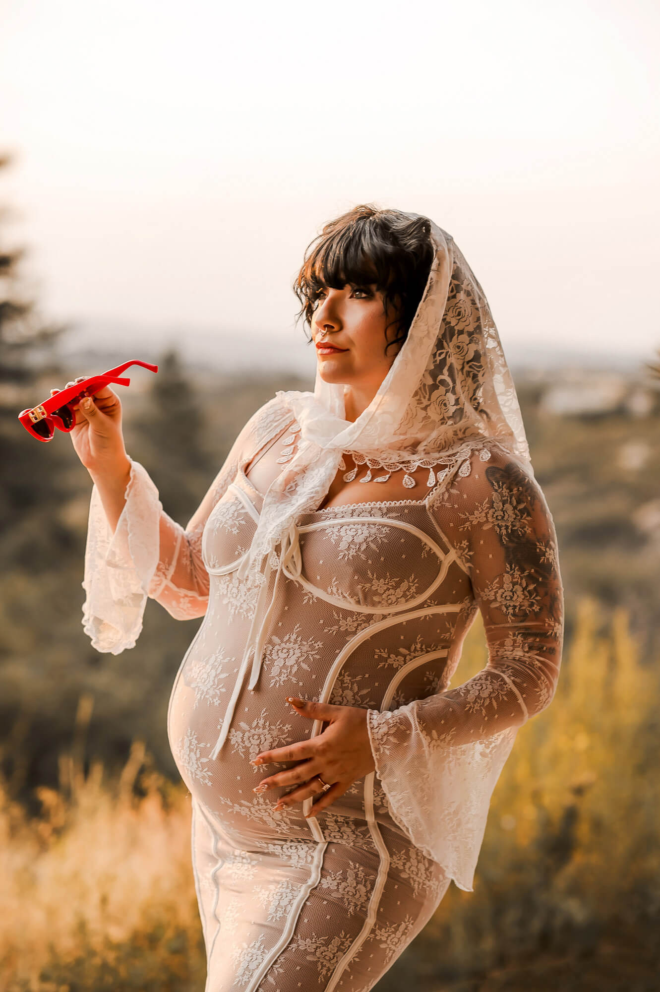 Retro Rockabilly Vintage Maternity Photoshoot in Denver Step back in time with this unforgettable retro-rockabilly styled maternity shoot. As a Denver maternity photographer, I love creating bold, timeless, and unique sessions. This vintage look blends classic lace, playful details, and old-Hollywood inspired confidence. Vintage Style Meets Motherhood First, we styled this session with a stunning lace gown and delicate veil. Then, we added red retro sunglasses to highlight a fun rockabilly vibe. The contrast between timeless lace and bold accessories brought her personality forward. Golden Light and Retro Energy Next, we moved outdoors into glowing golden light for dramatic, cinematic portraits. The warm tones paired beautifully with her vintage styling and radiant glow. Meanwhile, the natural setting added softness to balance her bold rockabilly energy. Why Choose a Retro Maternity Session Every maternity journey deserves a style that feels true to you. For some mothers, that means glamorous gowns and elegant posing. For others, it means bold accessories, playful energy, and unapologetic vintage flair. With a retro maternity photoshoot, your portraits become fun, unique, and timeless. Denver’s Perfect Backdrop for Vintage Maternity Photography Denver’s natural beauty makes the perfect backdrop for creative styled sessions. From foothill landscapes to golden sunsets, the scenery always enhances the story. Adding retro fashion creates unforgettable maternity portraits with personality and charm. Book Your Own Retro Maternity Experience Are you ready to embrace a maternity session full of vintage glamour? Let’s create bold, fun, and timeless maternity portraits that feel uniquely you. Contact me today to book your retro rockabilly maternity photoshoot in Denver.